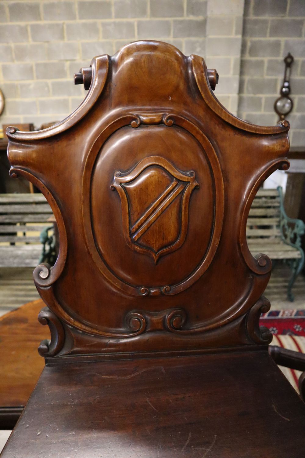 A pair of Victorian carved mahogany hall chairs